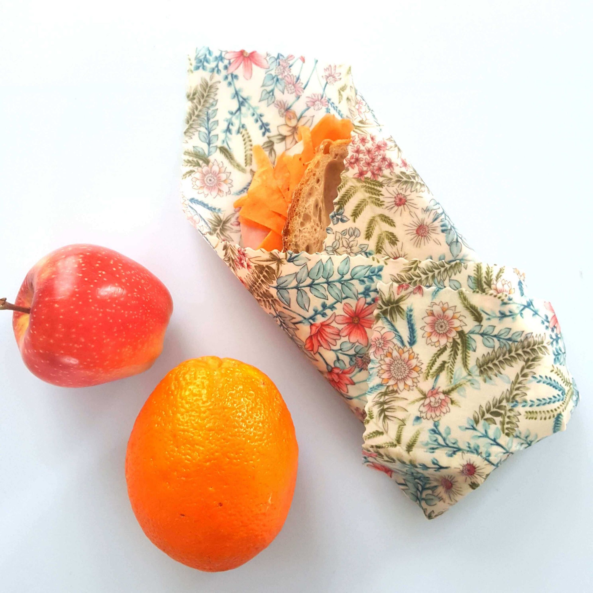 Reusable Beeswax Food Wraps 100% Hand Made in the UK by Honey Bee Good shown in Set of 3 Classic Botanical on sandwich