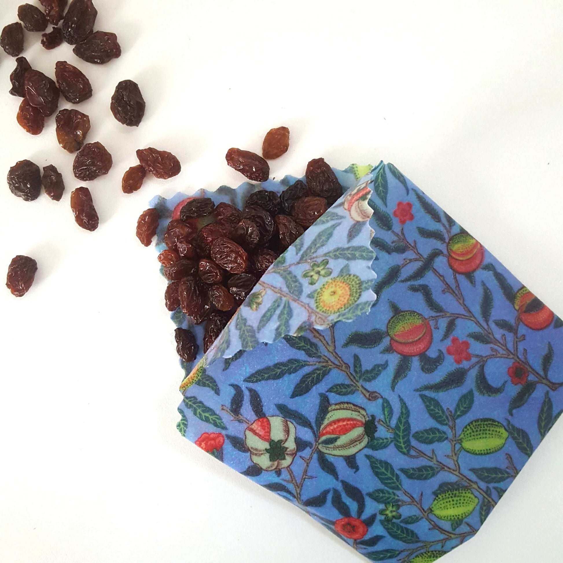 Reusable Beeswax Food Wraps 100% Hand Made in the UK by Honey Bee Good shown in William Morris Pomegranate flatlay