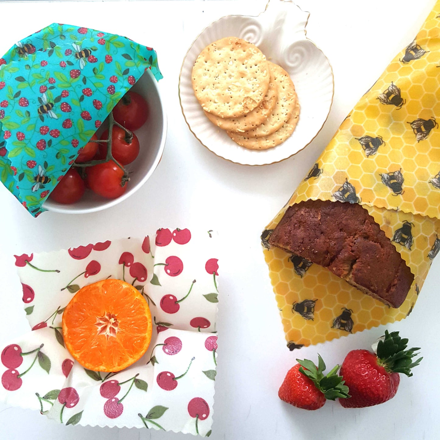 Reusable Beeswax Food Wraps 100% Hand Made in the UK by Honey Bee Good shown in Set of 3 Classic Bees & Cherries flatlay