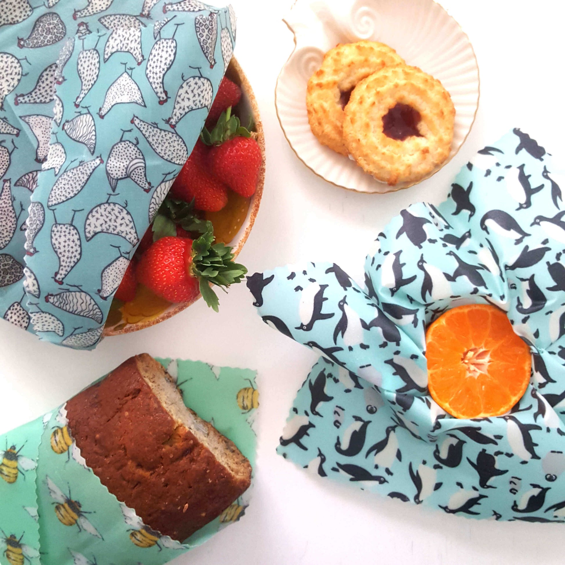 Reusable Beeswax Food Wraps 100% Hand Made in the UK by Honey Bee Good. Earth Kind Classic set of 3 in Penguins, Hens & Bees flatlay